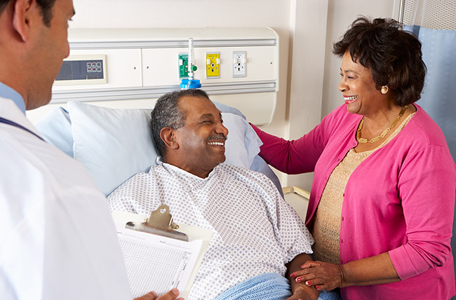 Stock photo of patients laughing with doctor